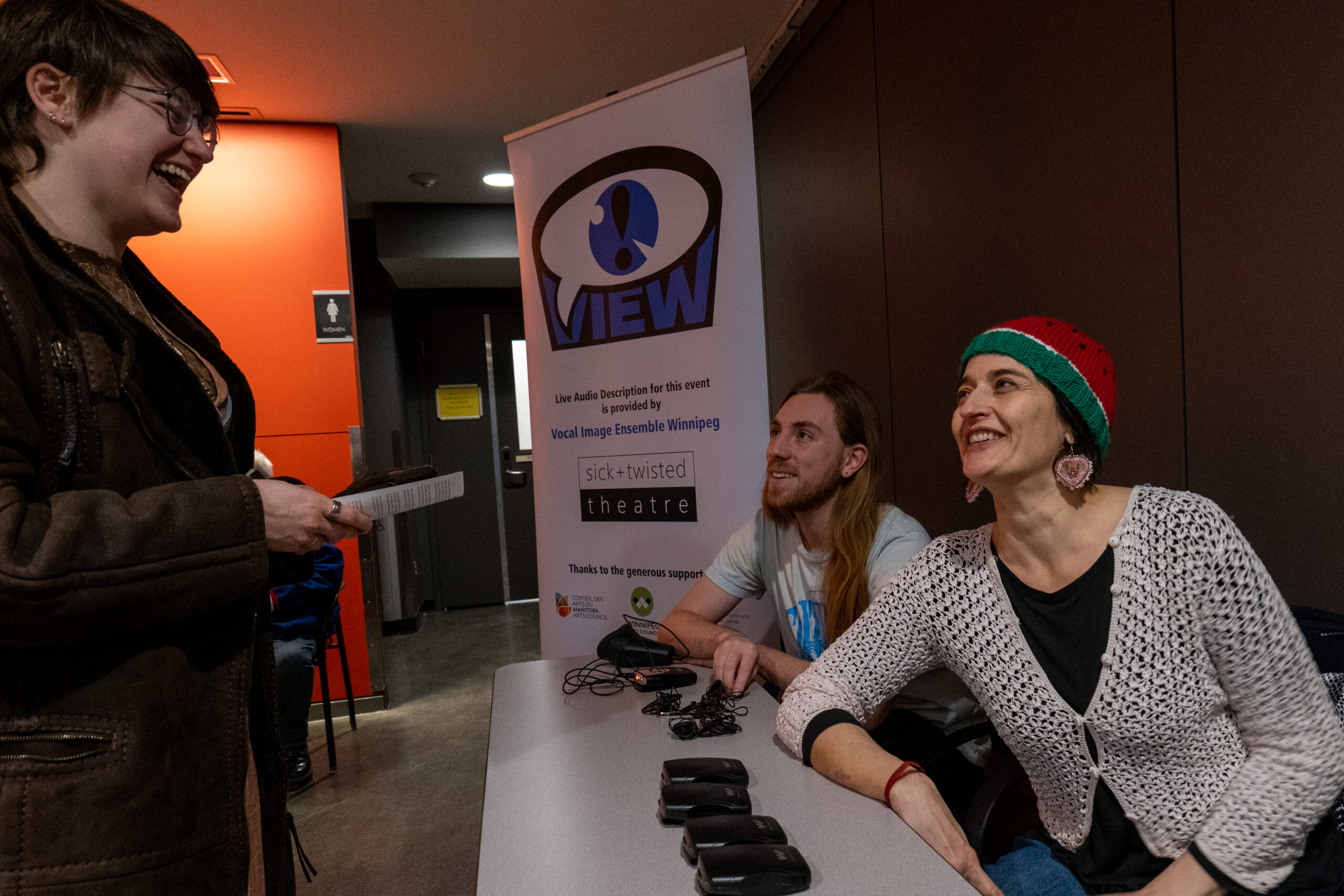 VIEW team members chatting in a theatre lobby