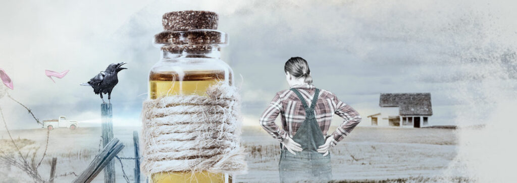 Grey farmland, grey skies. A woman in a plaid shirt and overalls looks into the distance, her hands on her hips. A corked glass bottle of yellow liquid looms in the foreground.